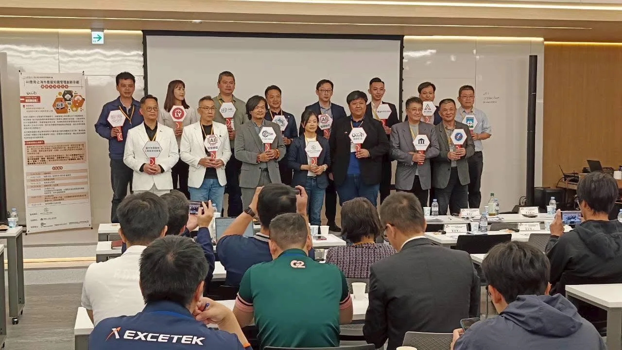Partners holding signs for a group photo on stage at Ocean Technologies' S Project Transformation results presentation